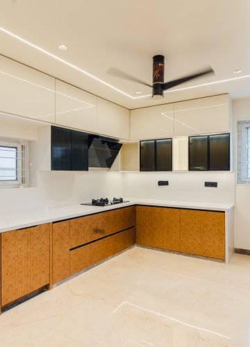 Modular kitchen with wooden base cabinets and white wall units