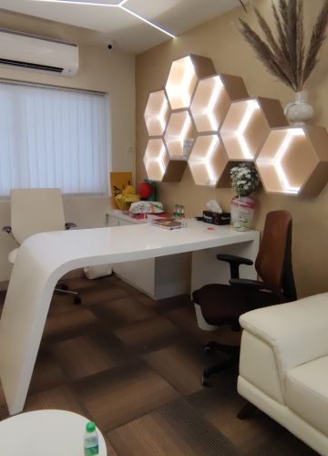 Office cabin interior with white desk and leather sofa