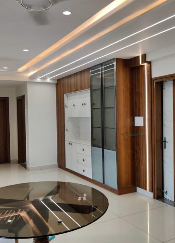 Living room and dining interior with glass table and wooden doors