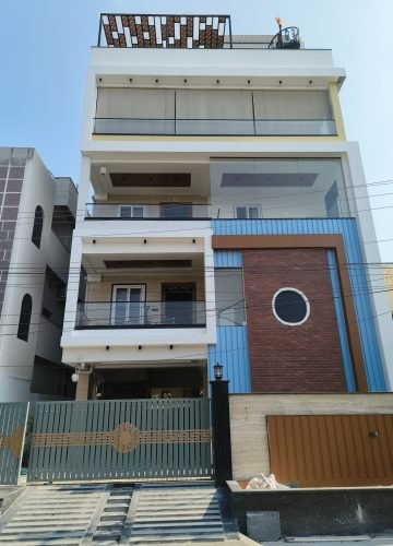 Modern G+3 house exterior with blue and brick facade – construction Hyderabad