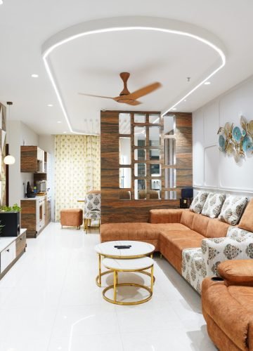 Living room interior with orange recliner sofa and TV wall
