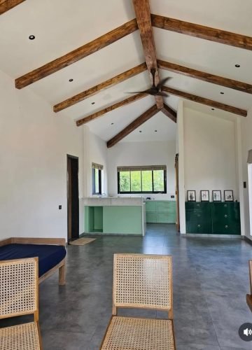 Farmhouse interior with exposed wooden roof trusses